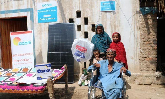 Pakistan Heatwave Appeal: How You Can Help Families Survive the Summer 10 A family posing outside their home in Sindh, Pakistan, next to a new solar panel, an Osaka battery box, and a standing fan provided by an aid program.
